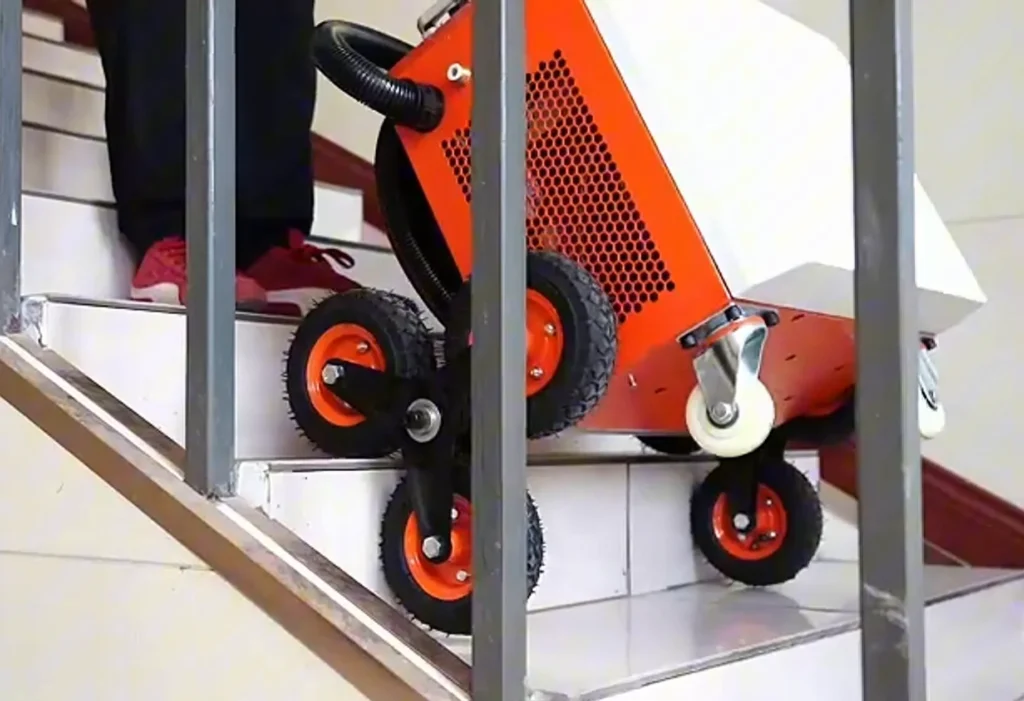 Le décapeur laser 500 W PRO monté marche après marche dans un escalier, en appui sur ses roues en étoile